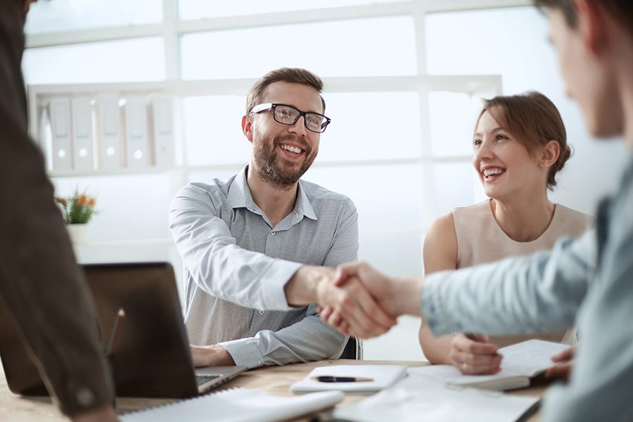 About Our Agency - Businessman at Yeager Insurance Agency Shaking Hands with His Colleague in the Office