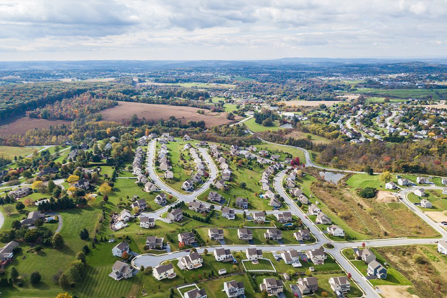 Contact - Aerial View of Rural Town and Surrounding Neighborhood in Pennsylvania During Fall