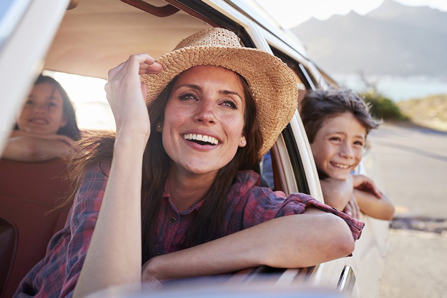 Personal Insurance - Mother And Children Relaxing In Car During Road Trip in the Summer