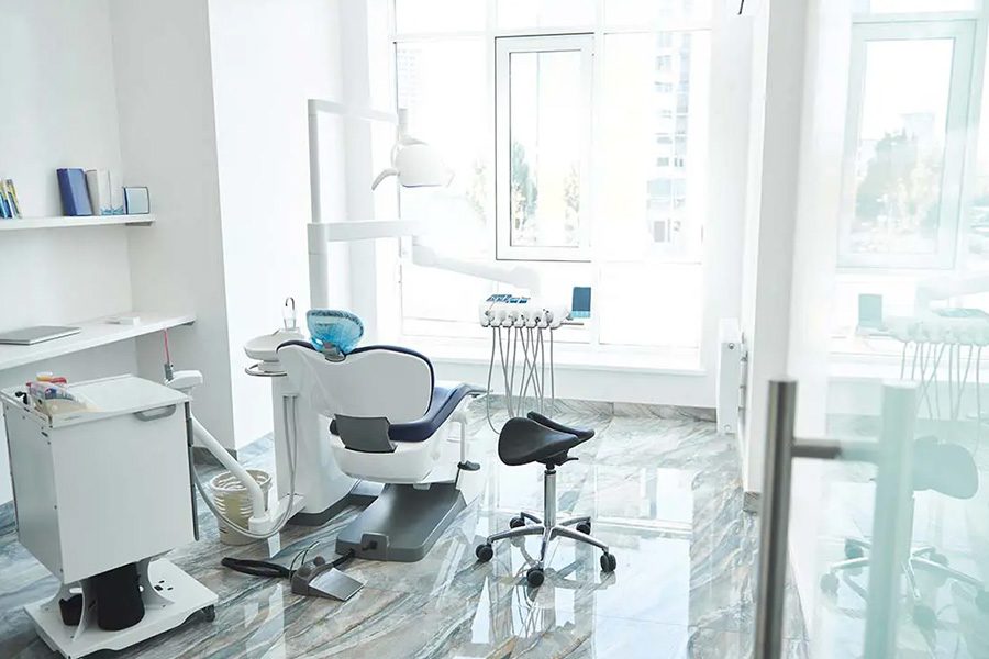 Dental Office Insurance - Empty Bright and Light Stomatological Room and Dentist Chair in a Modern Office Awaiting the Next Patient